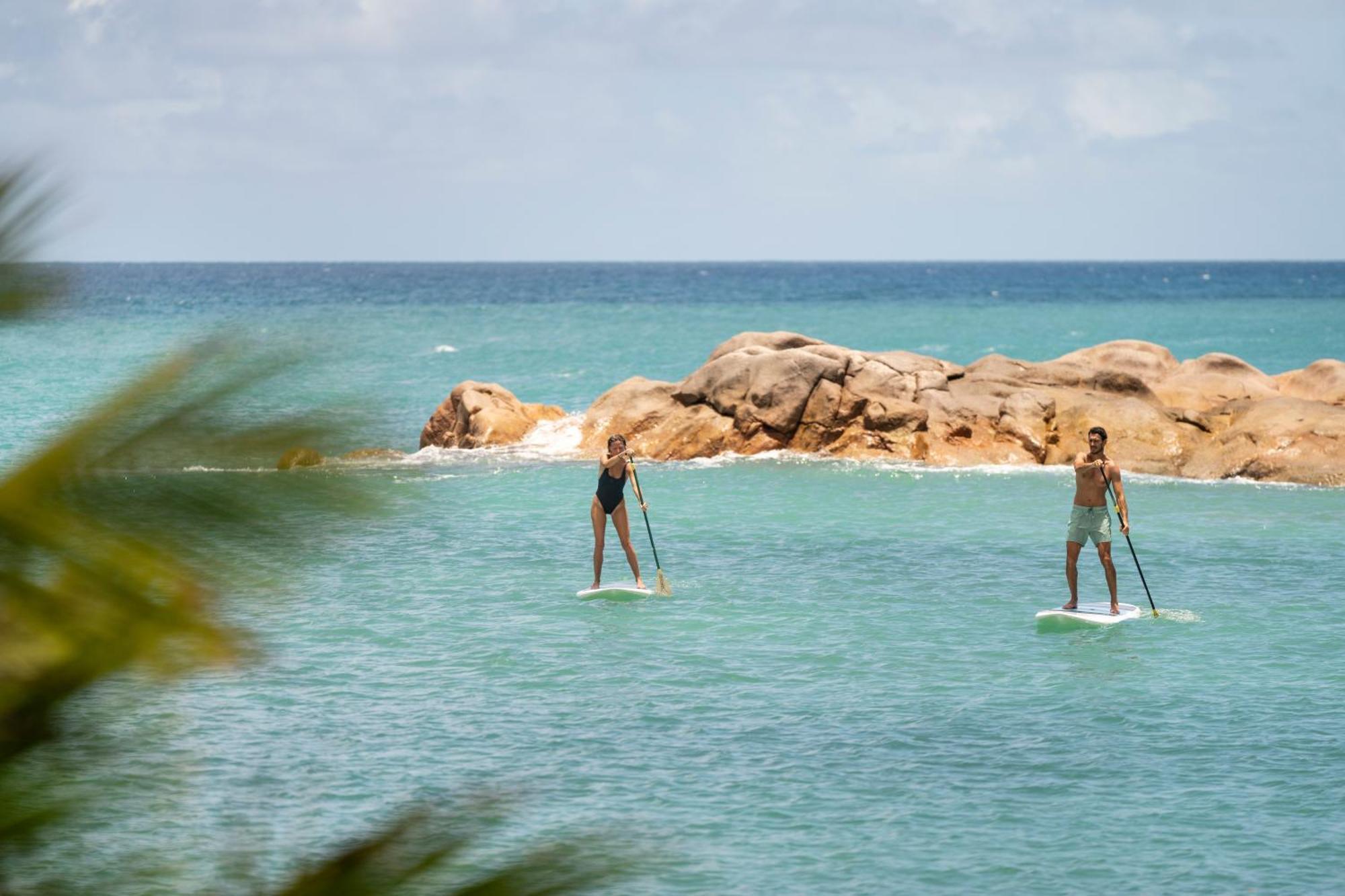 Constance Lemuria Grand Anse  Esterno foto Stand up paddle boarders on the bay